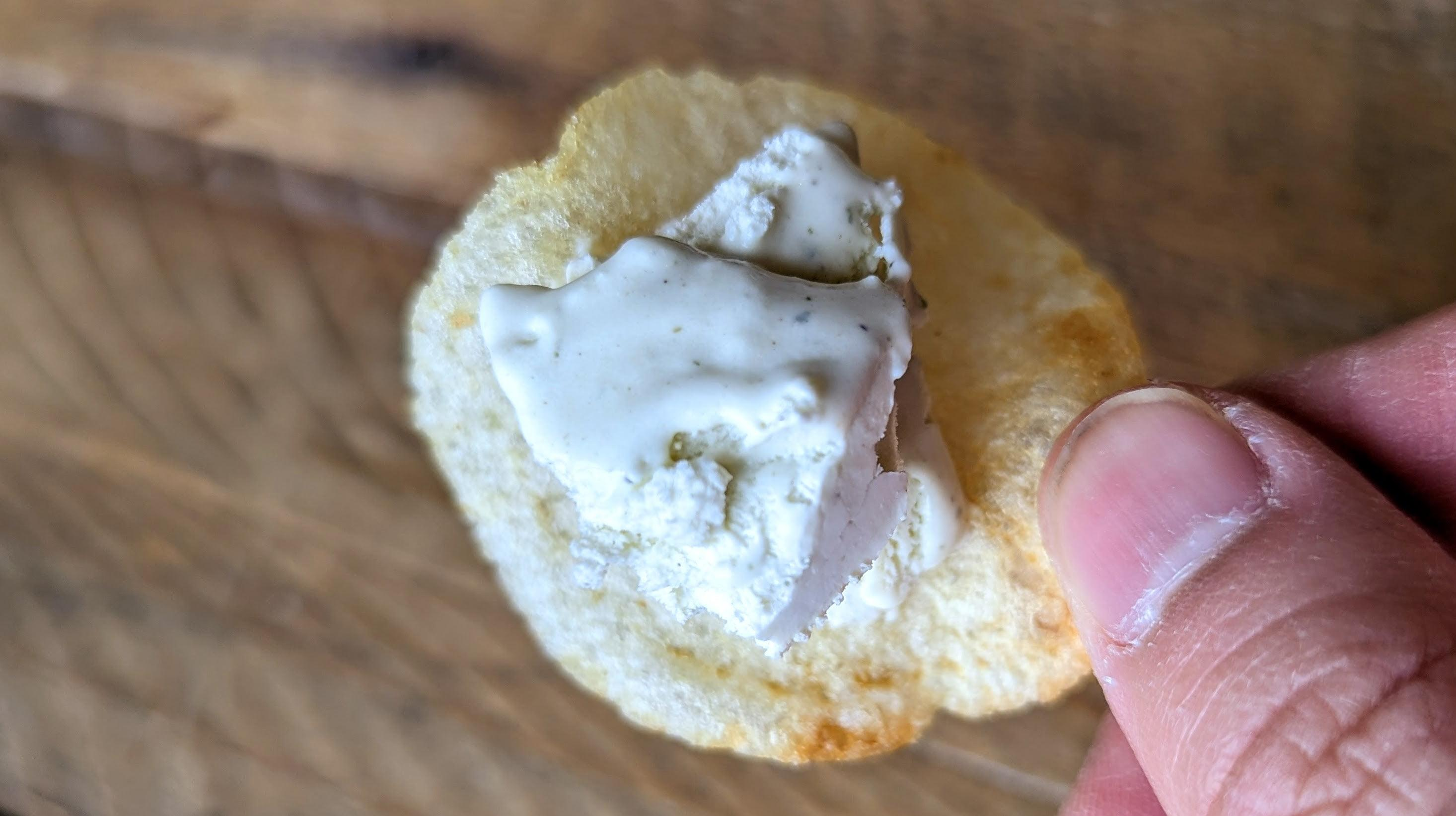 hand holding chip with ice cream