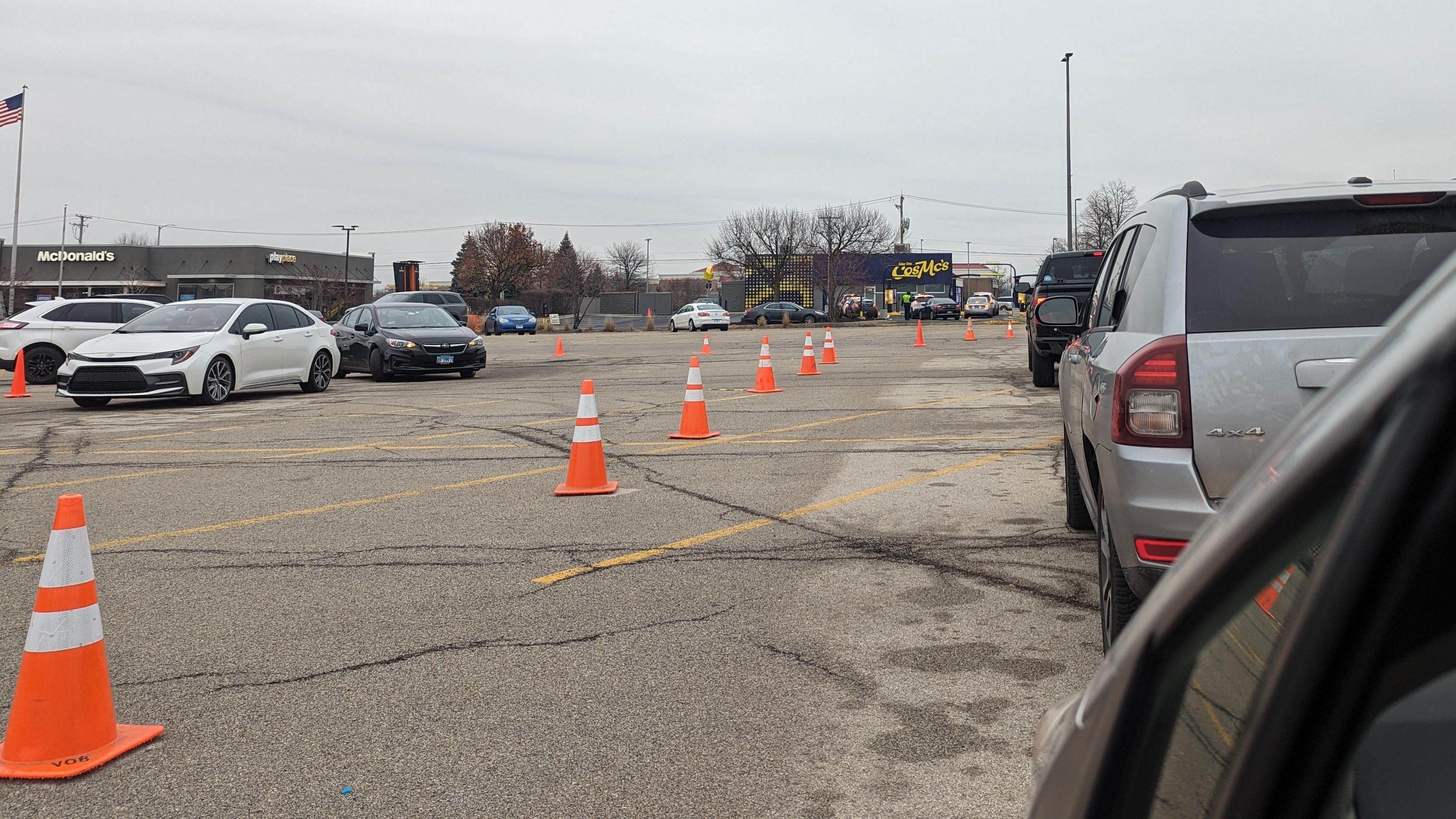 Parking lot with traffic cones and cars outside McDonald's and CosMc's