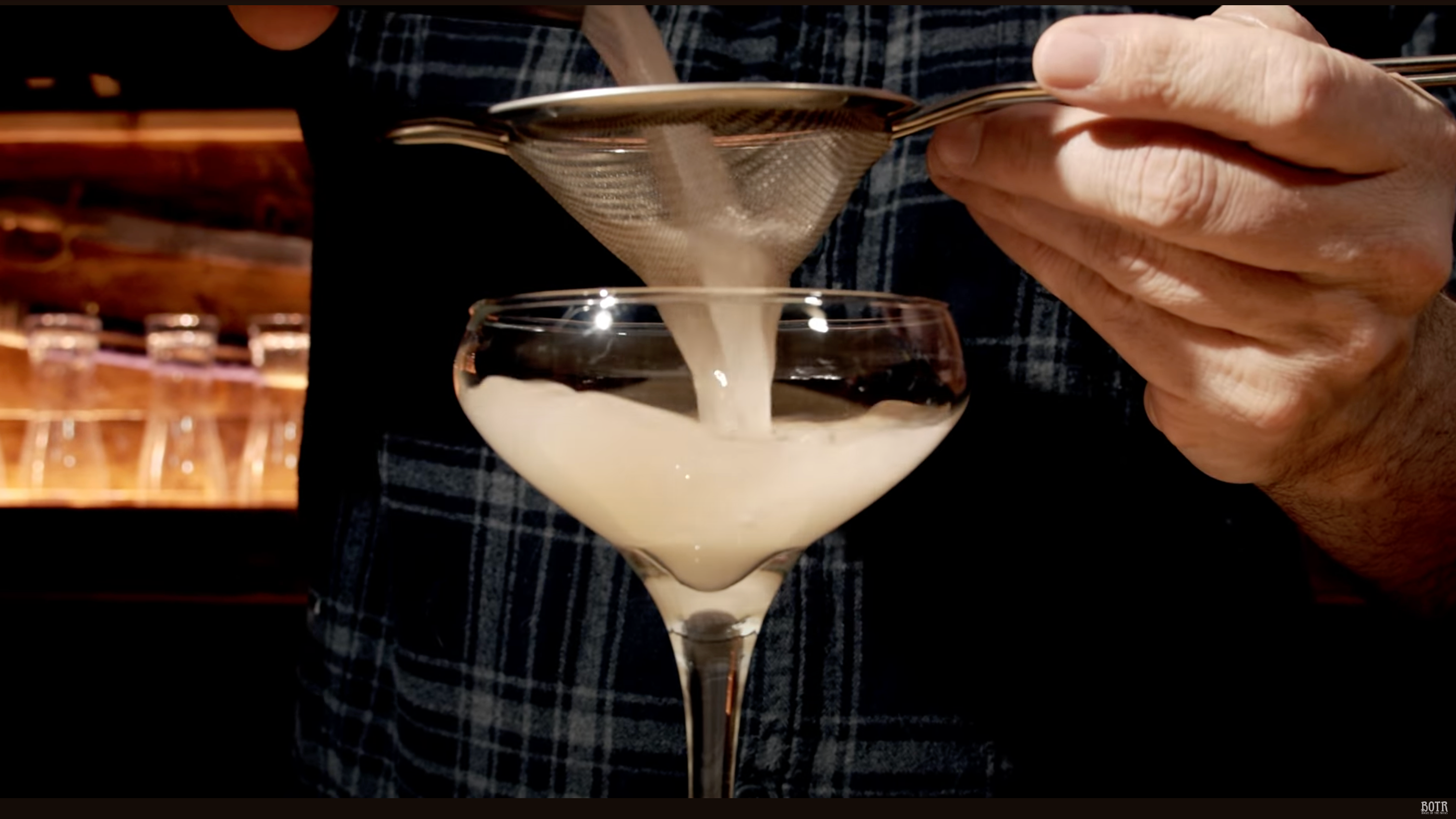 French Blonde cocktail being poured into a coupe glass
