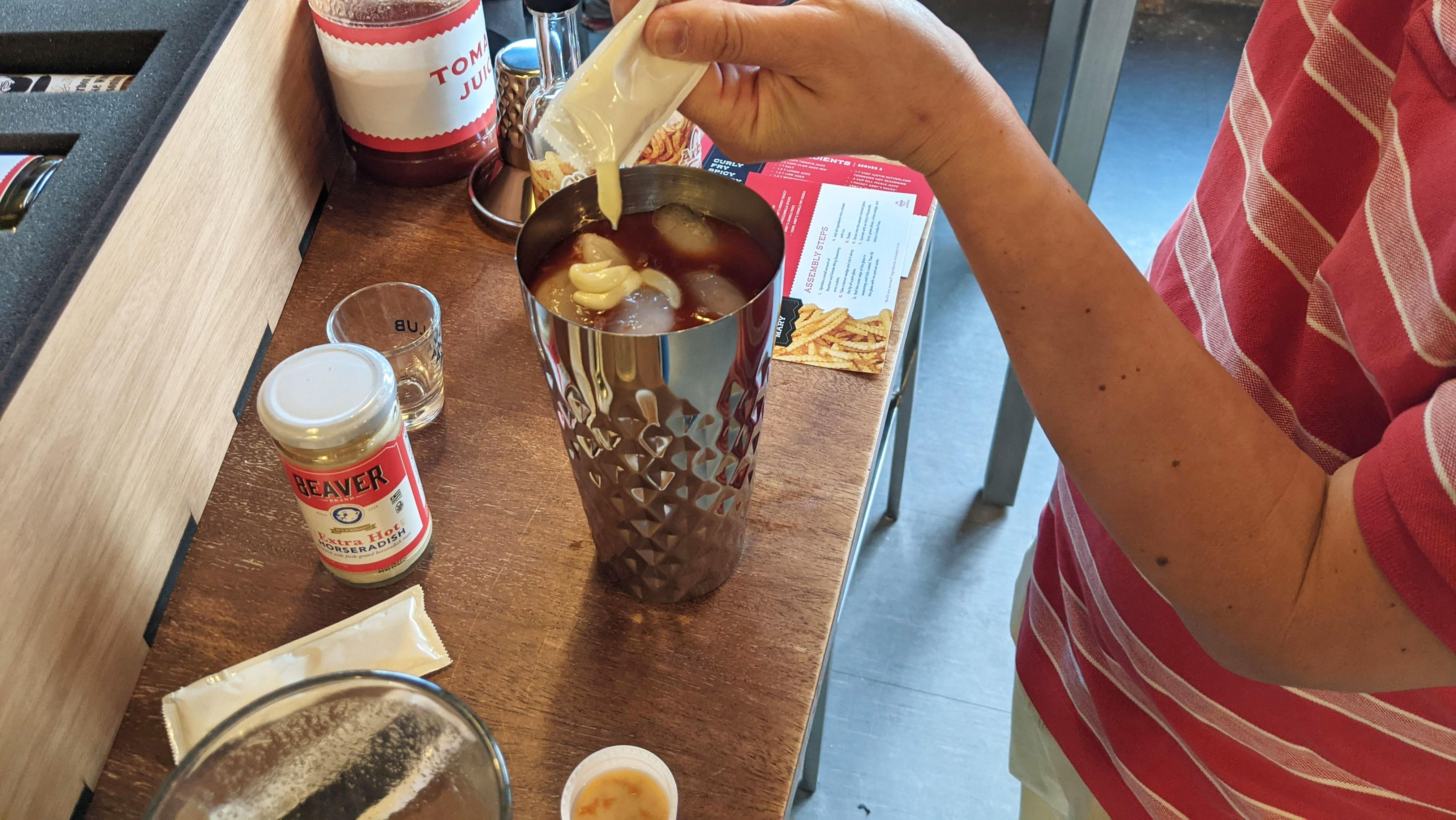 hands making cocktail