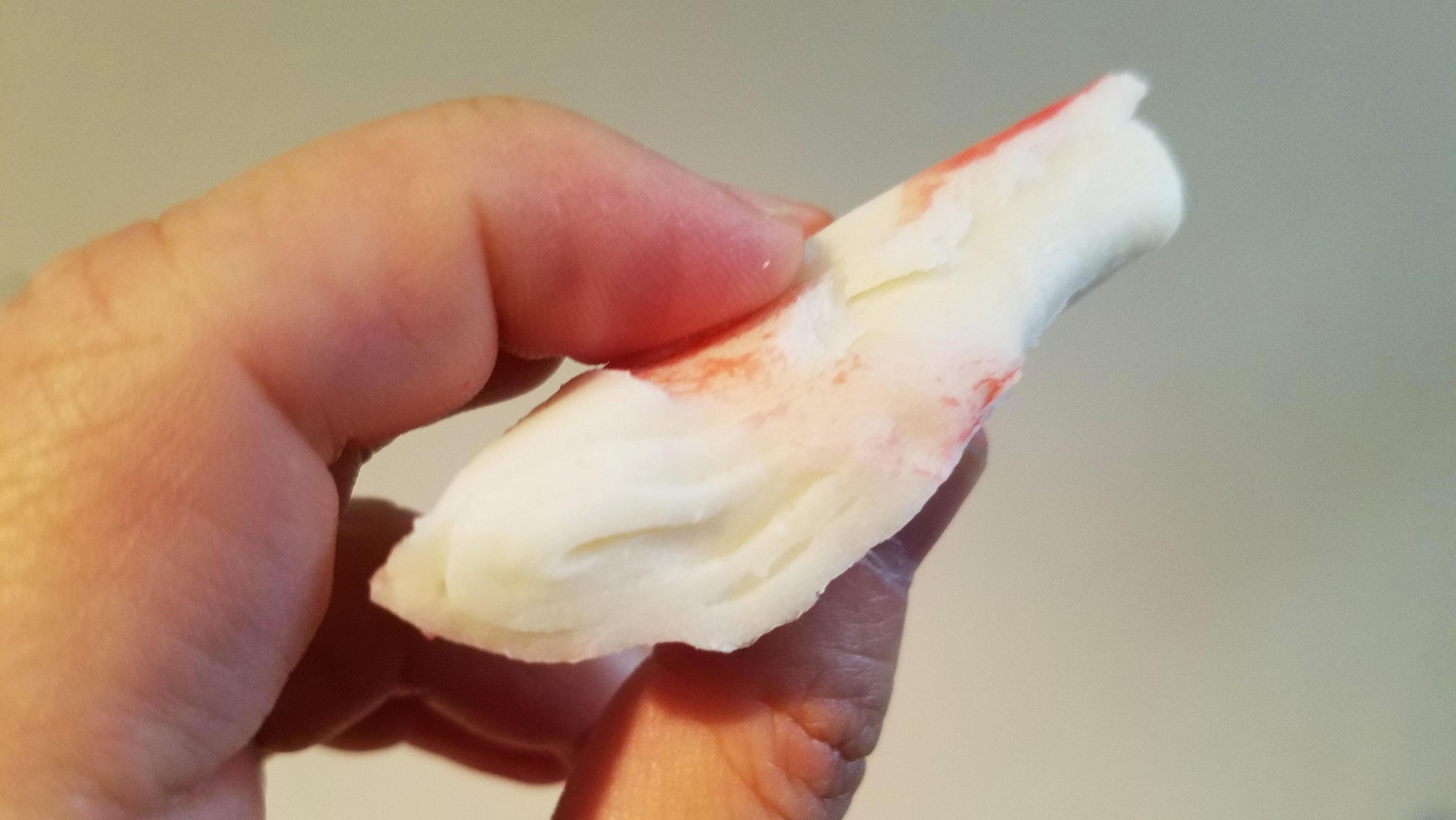 Closeup of surimi flake, approximately two inches across