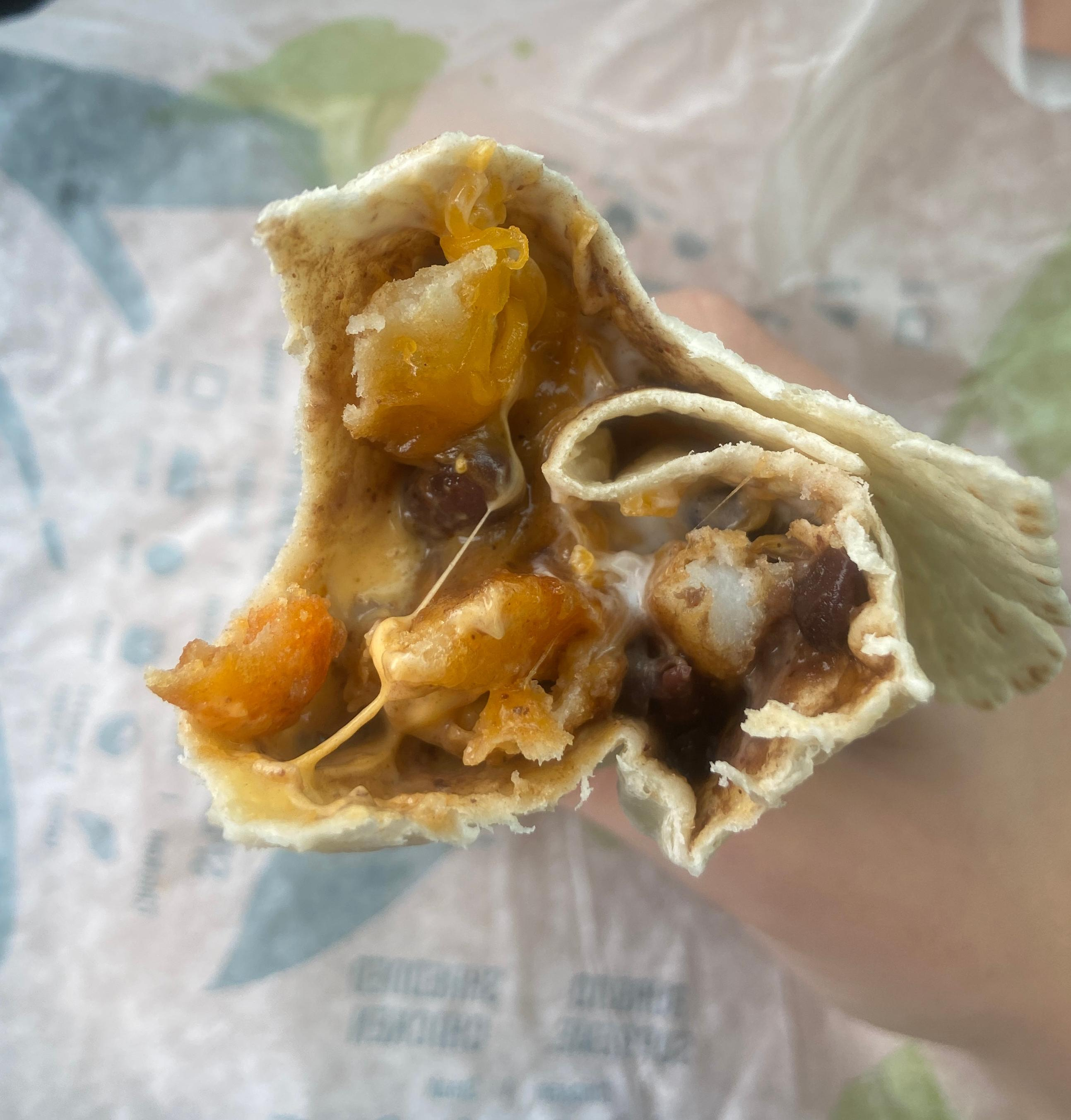 Close-up of White Hot Ranch Fry burrito with bite taken out of it