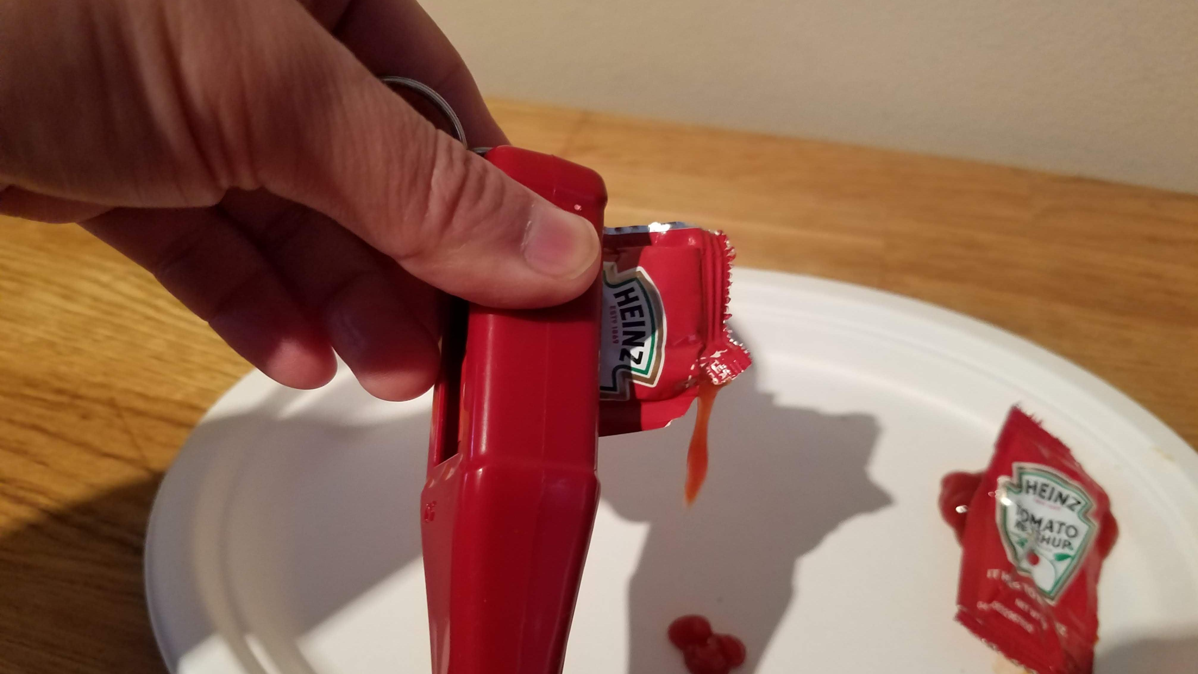 Heinz Packet Roller squeezing ketchup out of a loaded ketchup packet