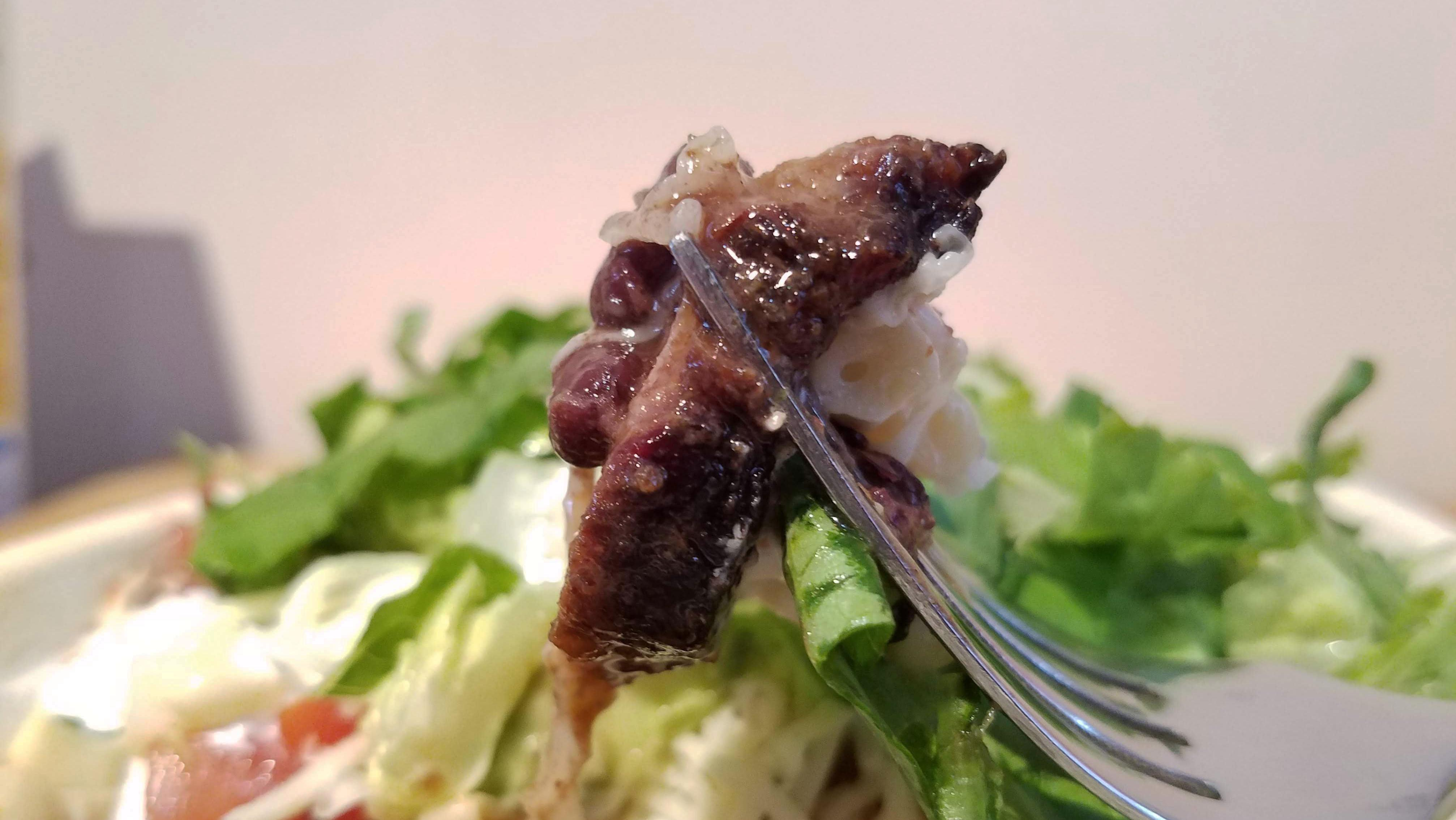 Close-up of a forkful of Chipotle brisket, with some bark visible on the exterior