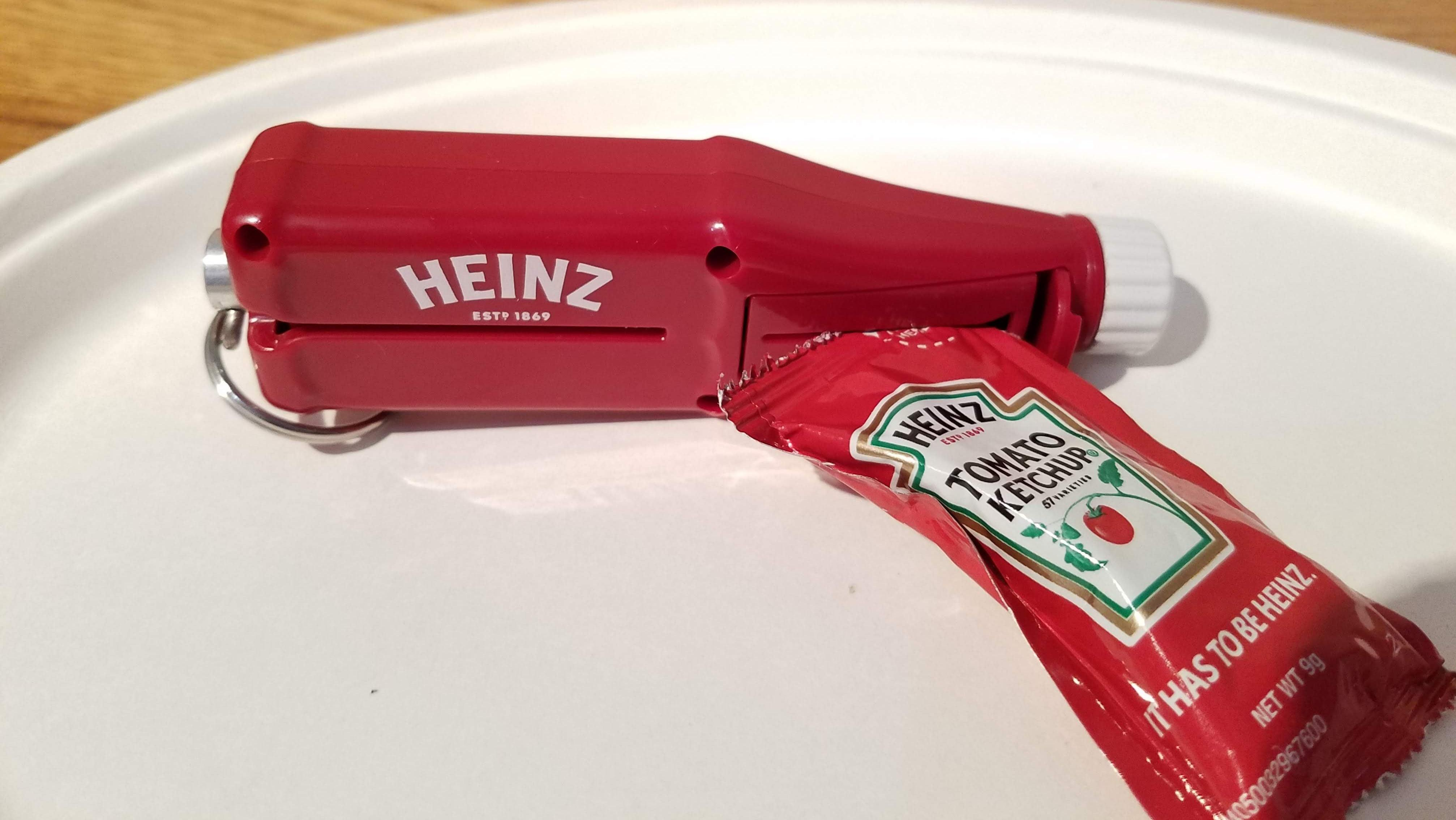 Heinz Packet Roller on a plate with a packet of ketchup ready to dispense