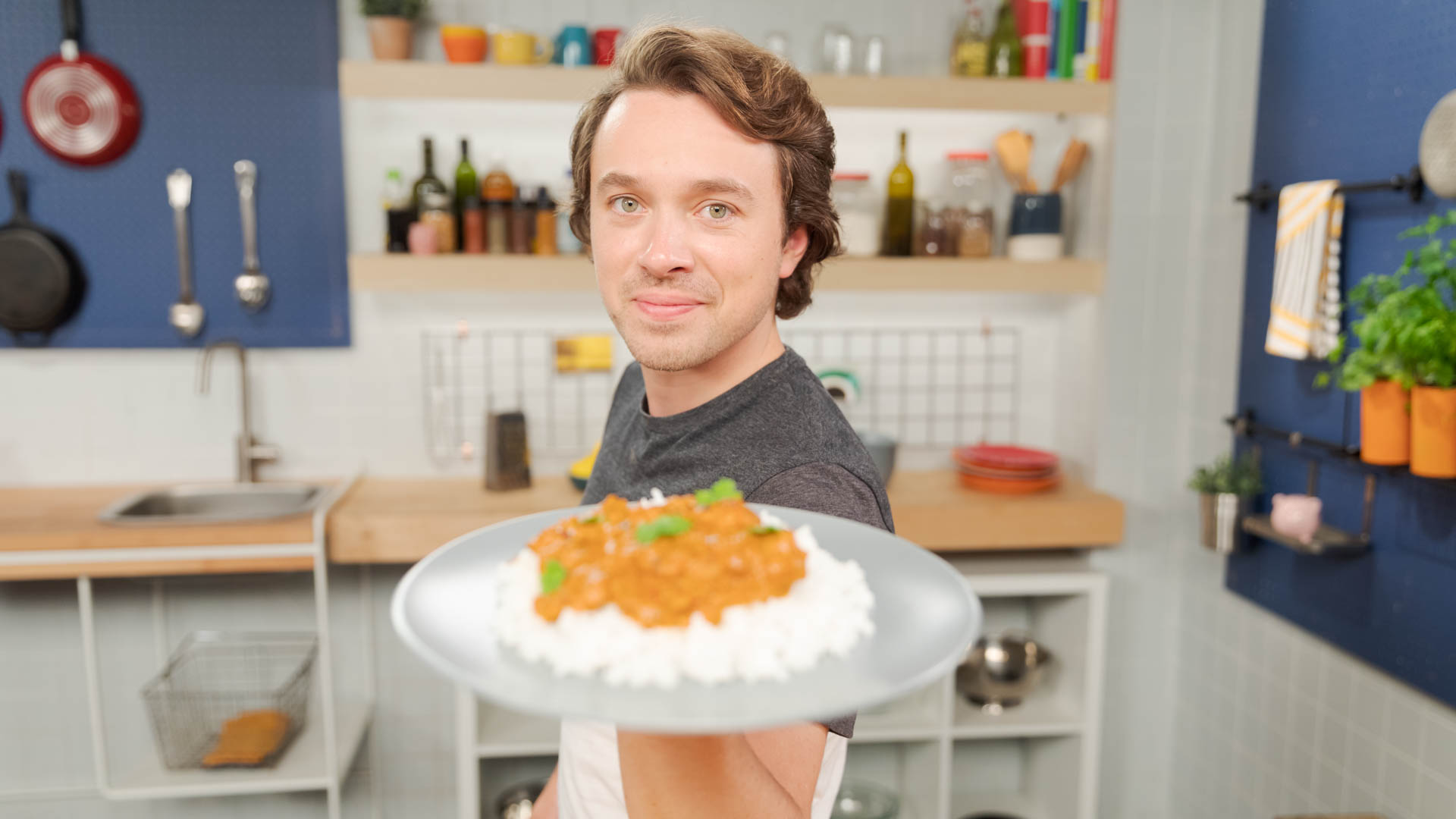 Celenza holding up plate with finished recipe