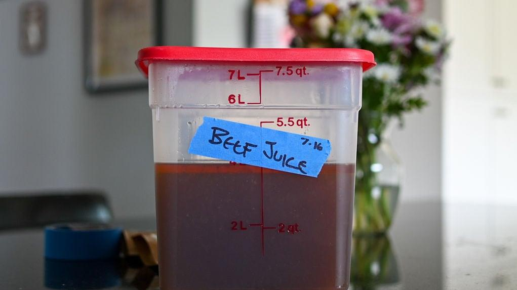 Tub of beef juice on counter