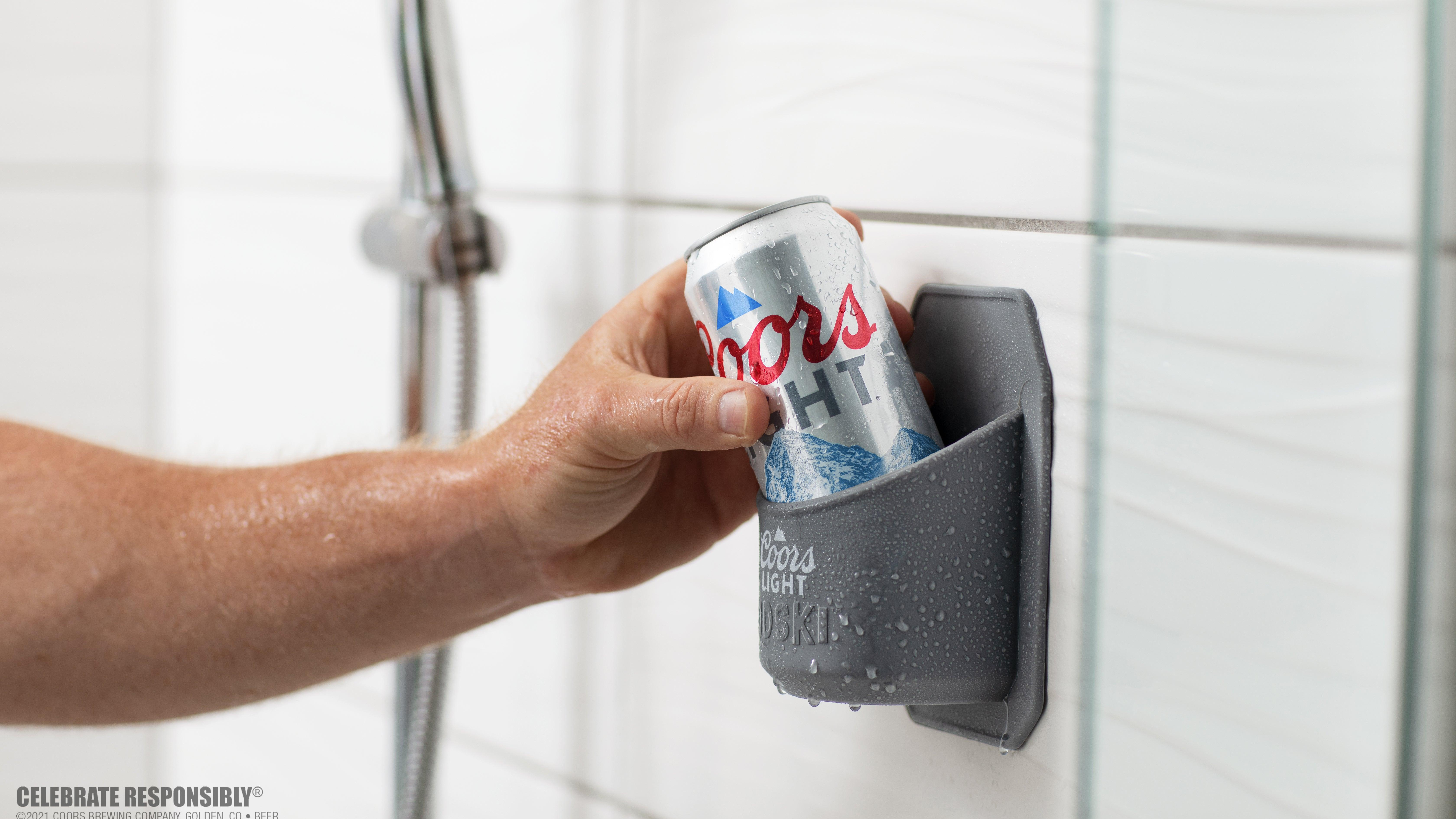 Coors can being placed in a Coors-branded shower caddy [image provided by Coors]