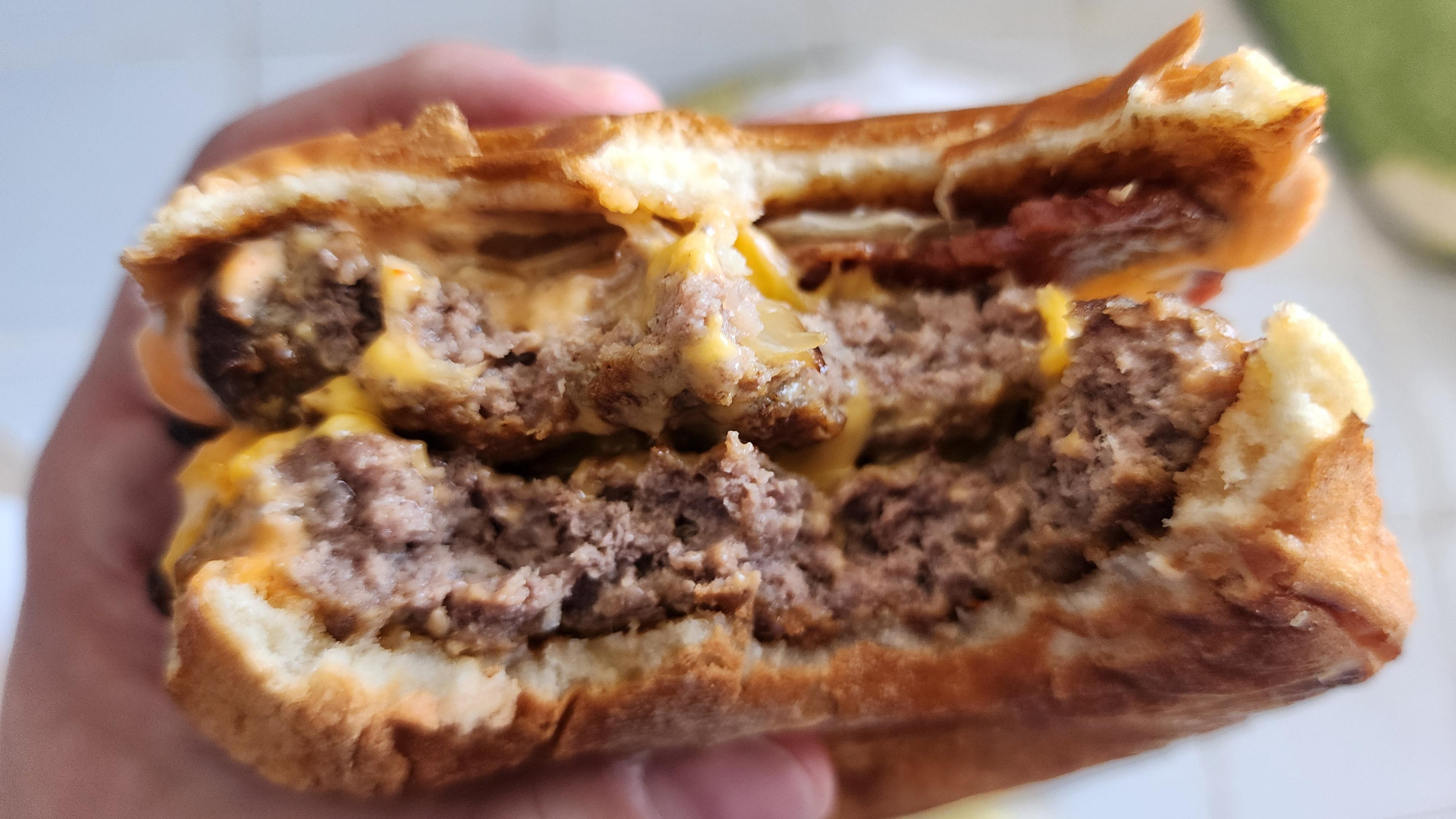 Burger bitten to show cross-section of the two burger patties