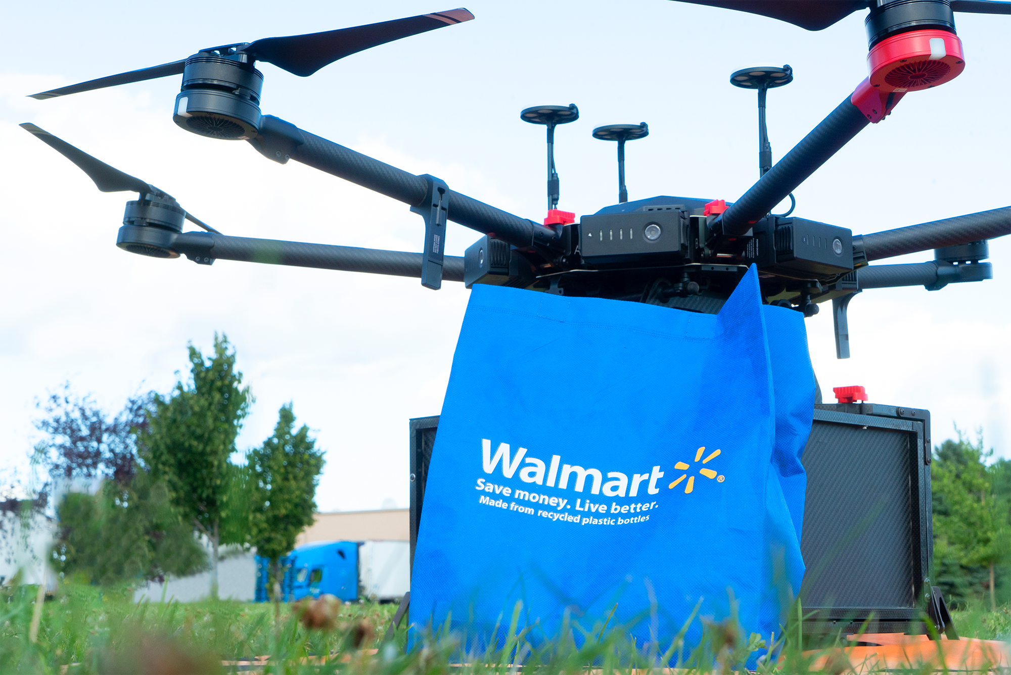 Ground-level shot of a Walmart bag being dropped off by a delivery drone