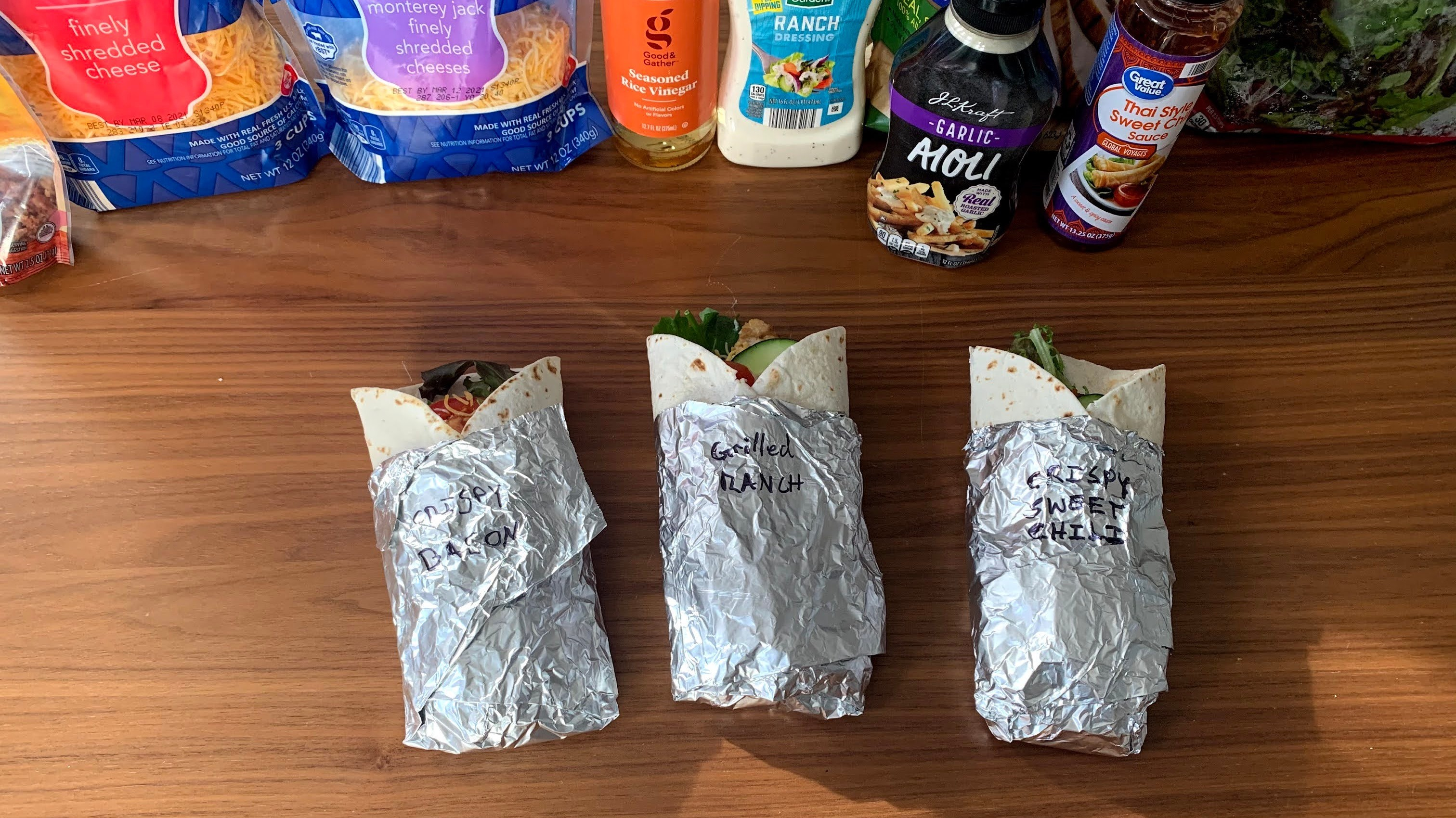 Three assembled imitation McWraps in foil on the kitchen table