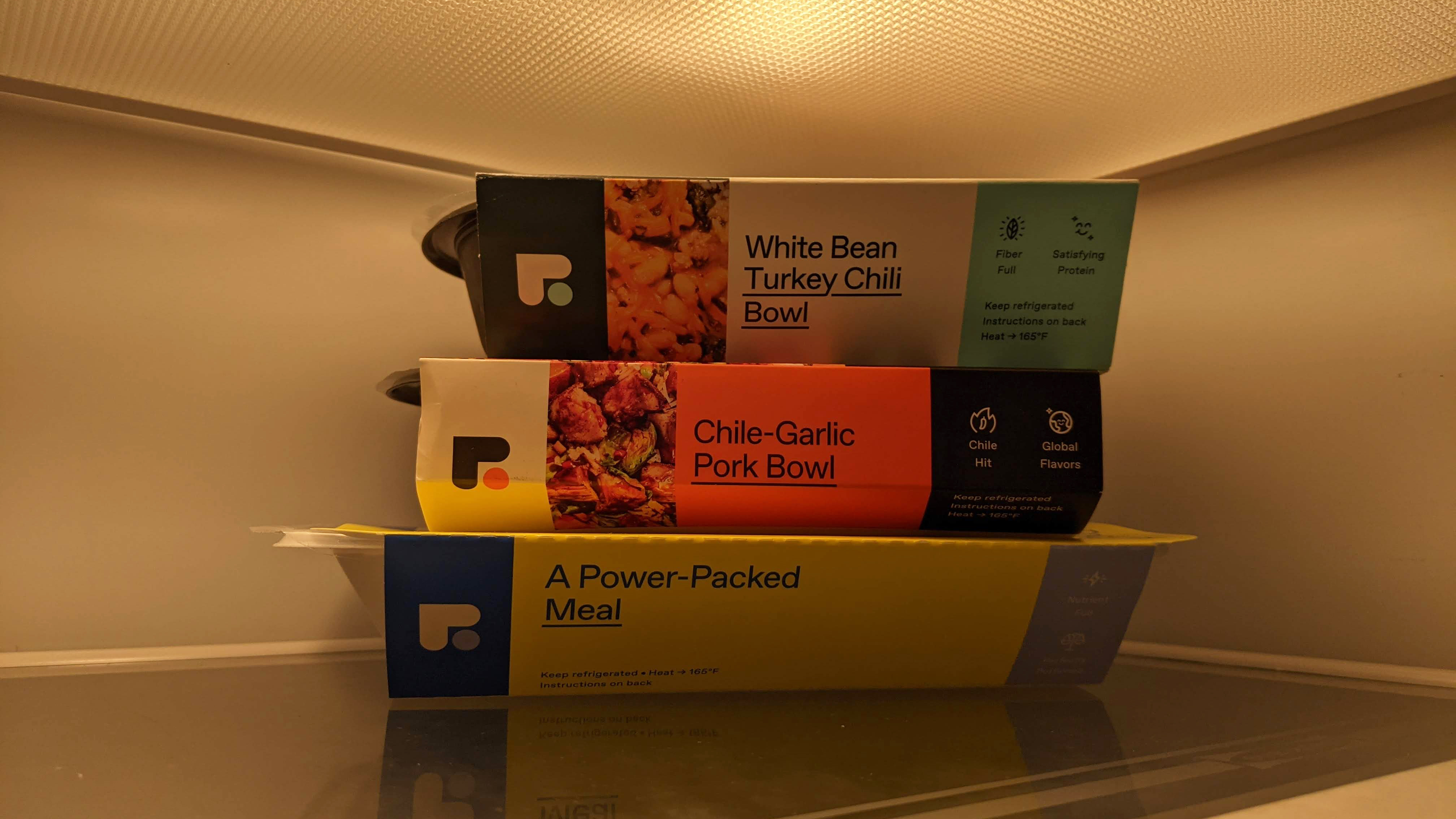 three Freshly meals stacked in the fridge