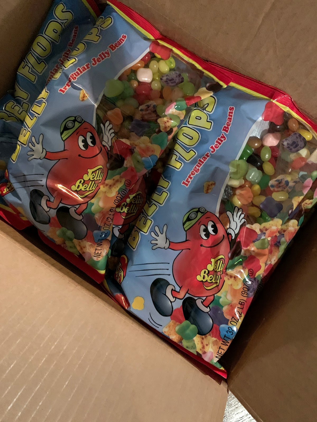 Open box revealing bags full of Jelly Belly's Belly Flops