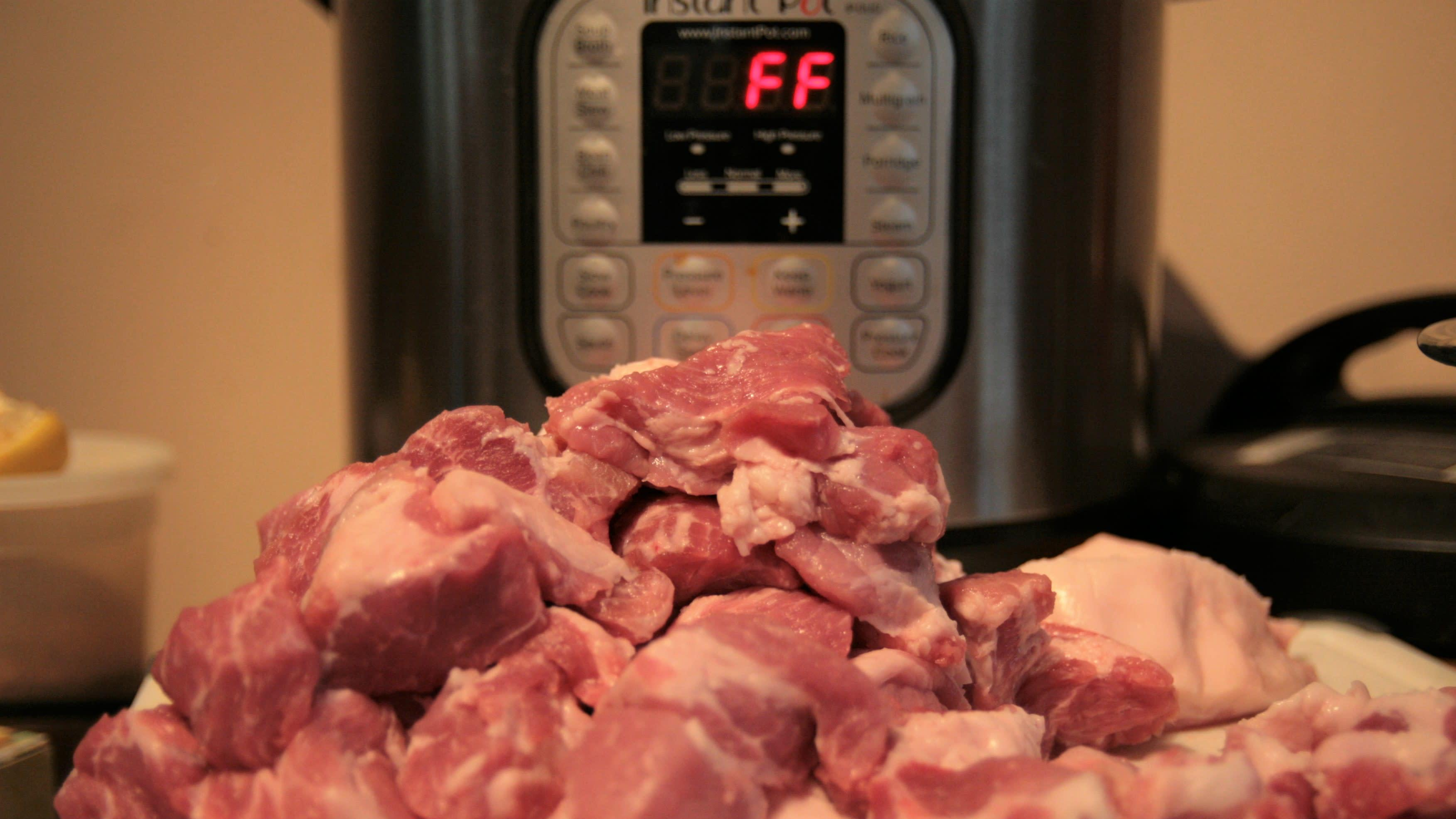 mound of chopped pork in front of instant pot