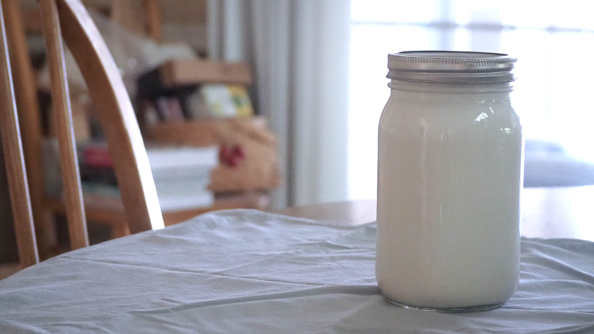 Jar of fresh cashew milk on the kitchen table