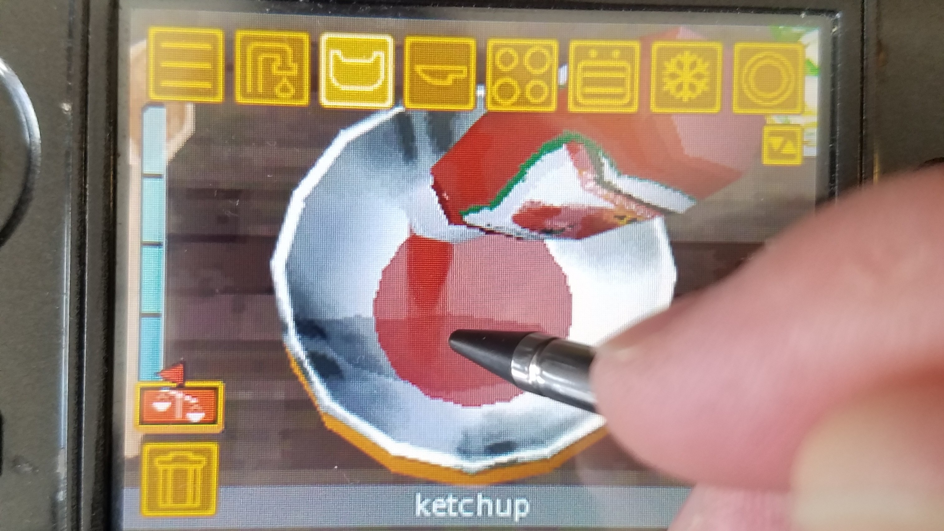 using stylus to pour ketchup into bowl