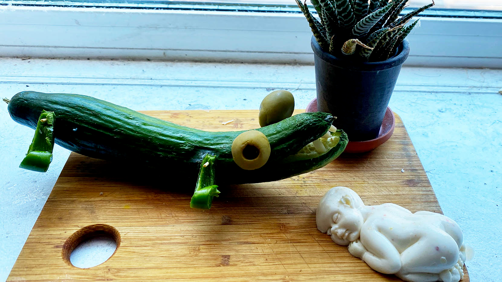 A Crocodile Cucumber watches over a Bacon Moussé baby