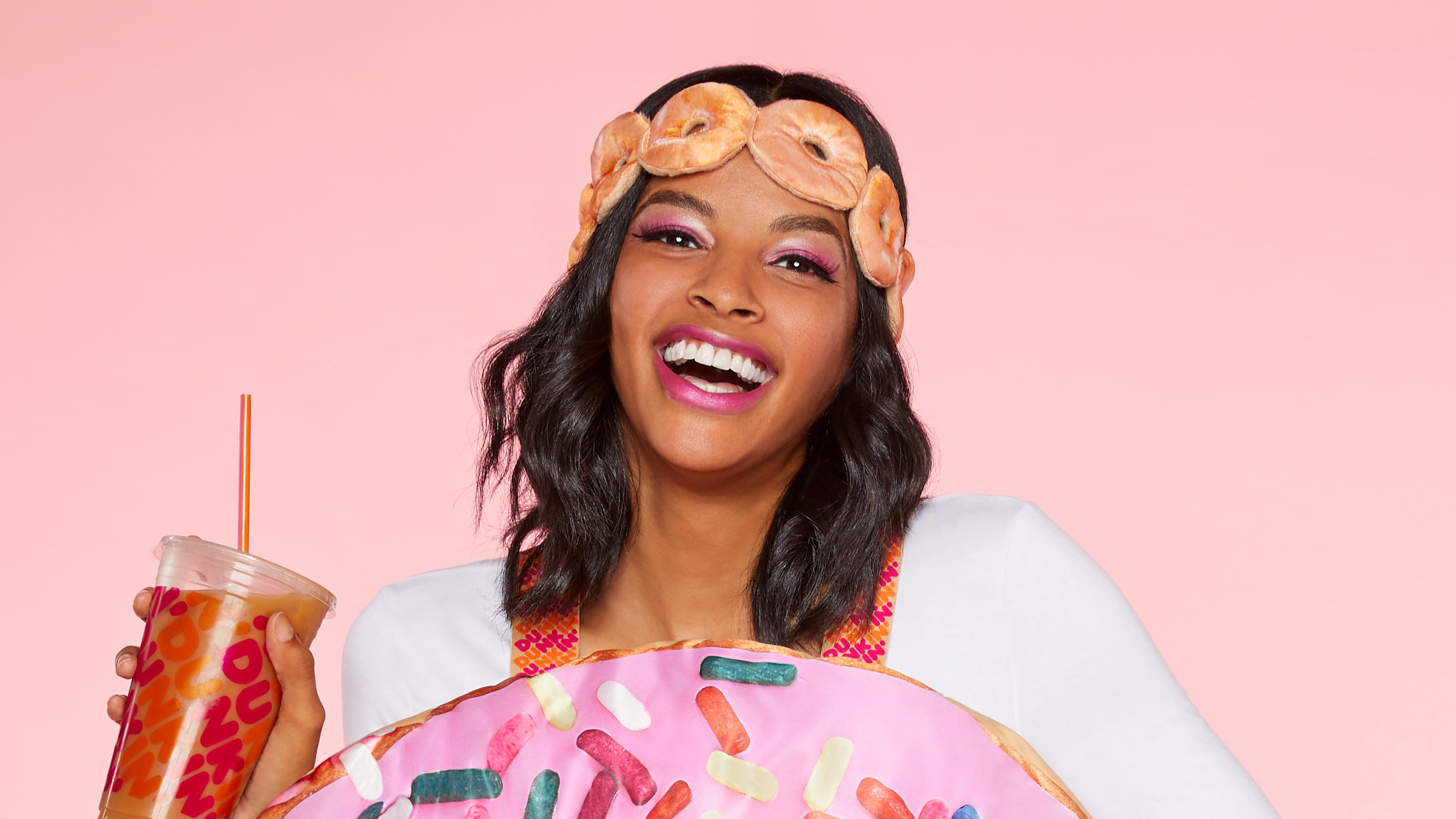 Close-up of woman in doughnut costume wearing a headband resembling a chain of doughnuts