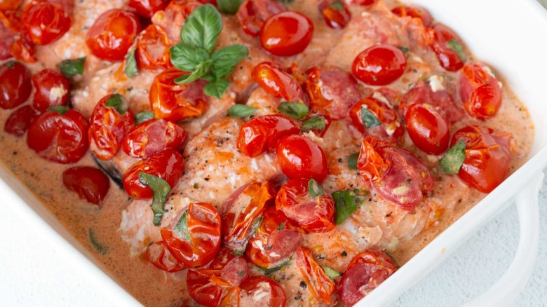 baked salmon with tomatoes in pan