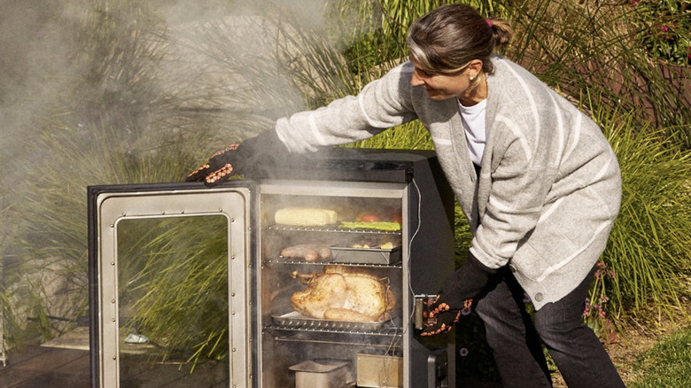 Person using an electric smoker