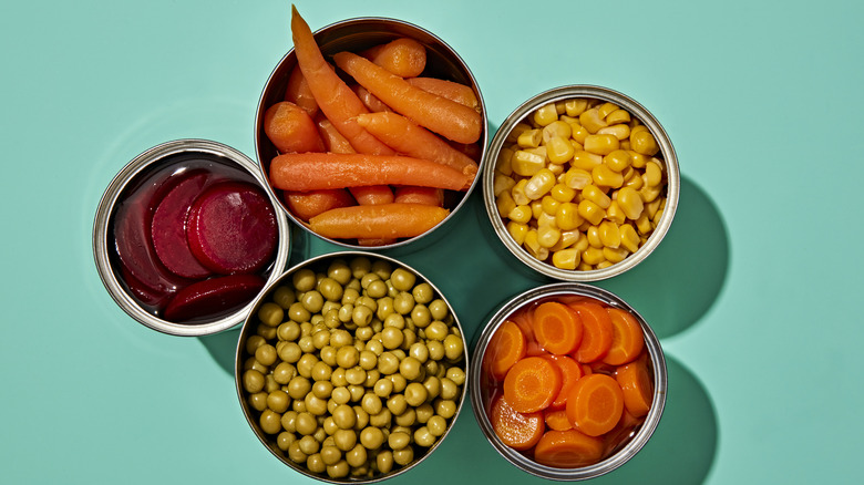 Cans of beets, peas, sweetcorn, and carrots