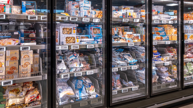 Frozen fish packaged and stocked in freezers at a grocery store