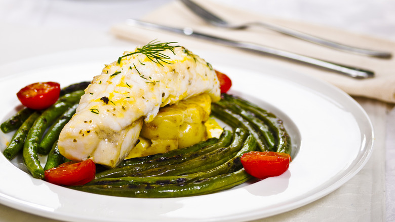 A monkfish tail served with green beans