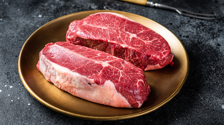 Raw steaks on a plate