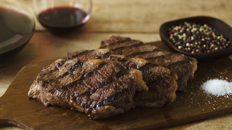 Cooked steaks on a wooden board