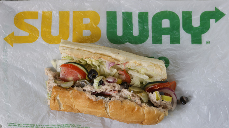 Subway tuna sandwich sitting on a wrapper with the Subway logo