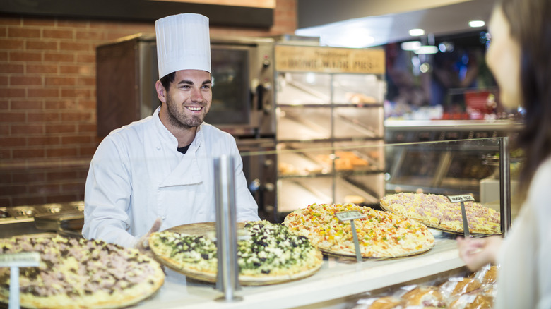 Chef with pizzas on display