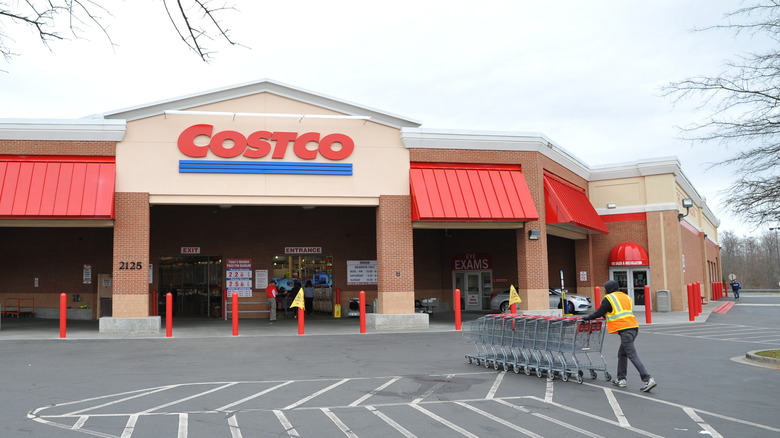 A Costco employee collects shopping carts