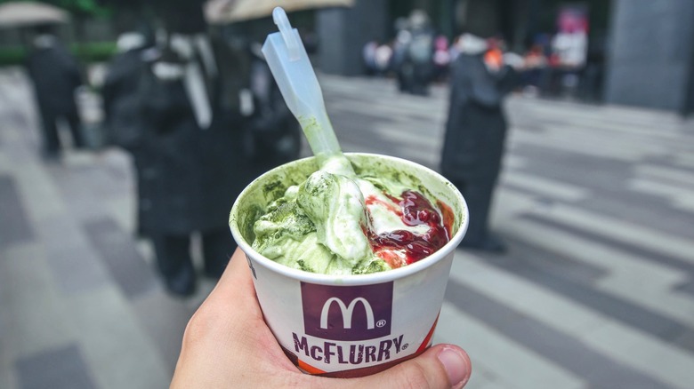 Hand holding Matcha McFlurry from McDonald's