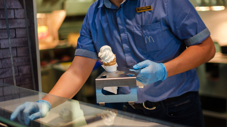 McDonald's worker serving ice cream cone