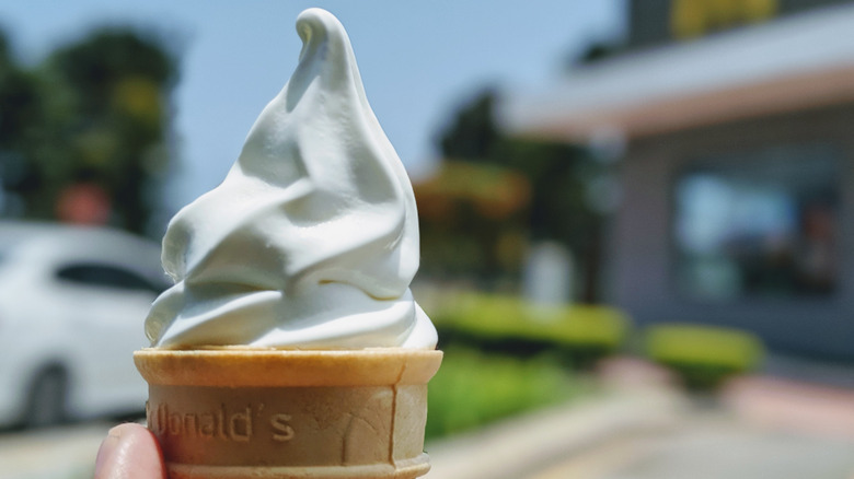 Hand holding vanilla cone from McDonald's