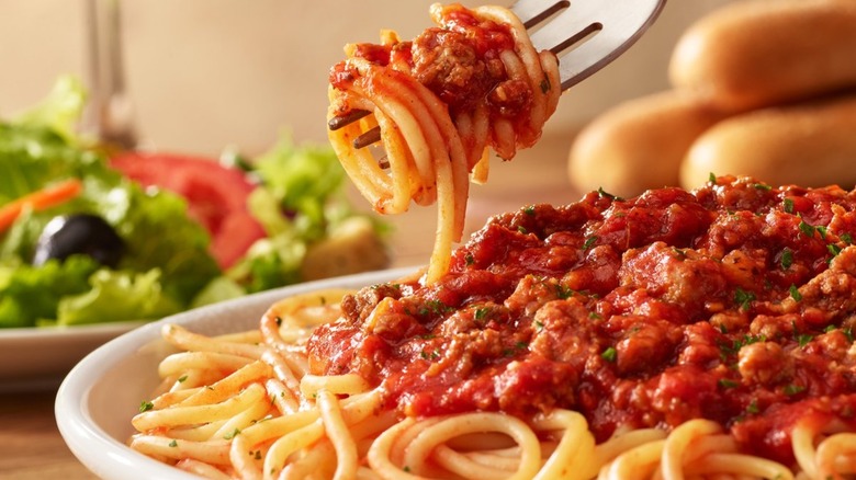 Fork taking spaghetti from a bowl of pasta