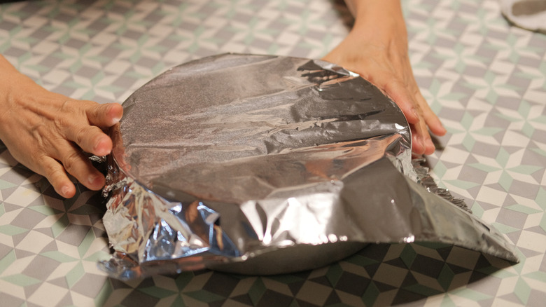 Aluminum foil covering a cake tin