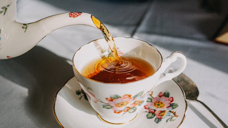 Pouring cup of tea