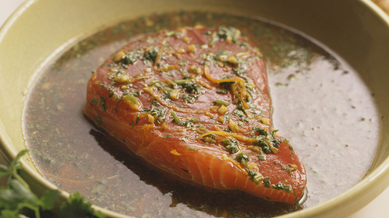 Raw salmon fillet in a brine