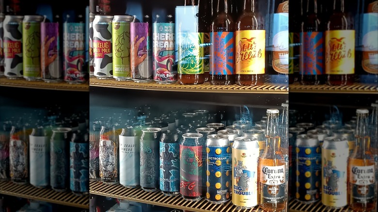 Various cans and bottles of beers in a fridge