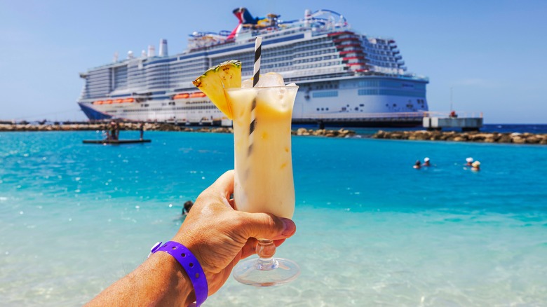 Cocktail held up in front of cruise ship