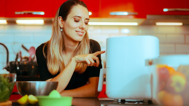 Woman using an air fryer