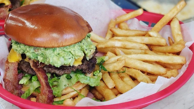 Reindeer burger in a basket with a side of fries