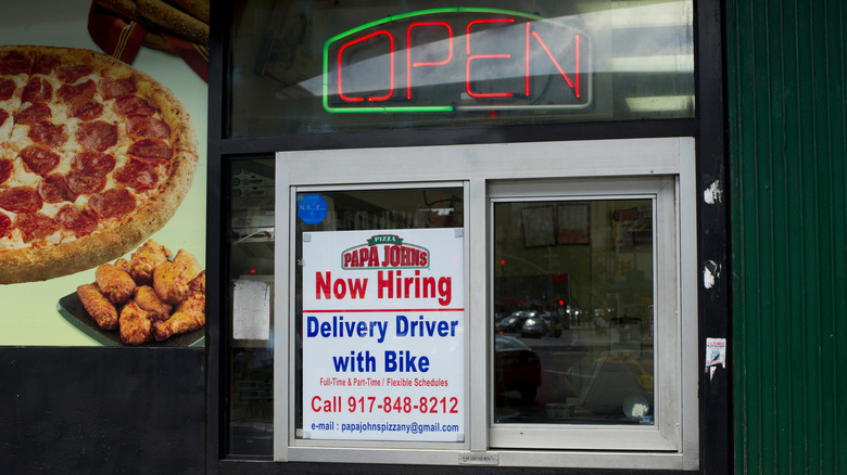 Window advertising for Papa Johns delivery drivers