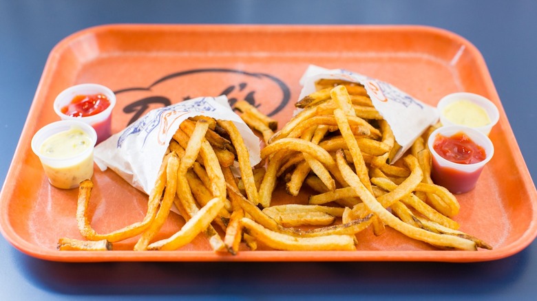 french fries, sauces on tray