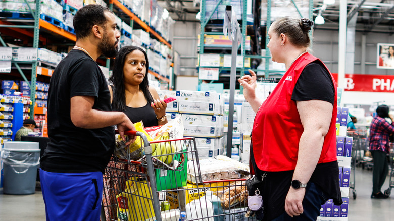 A couple talks to a staff member at Costco