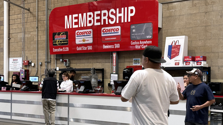 People working at membership booth in Costco