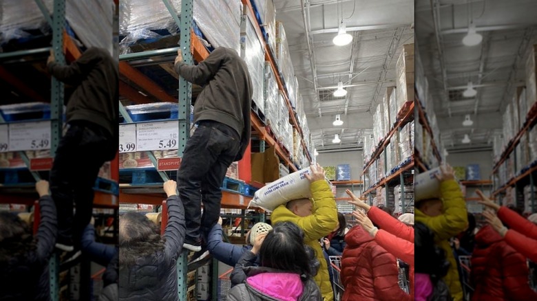 Man climbs large display stand at crowded Costco