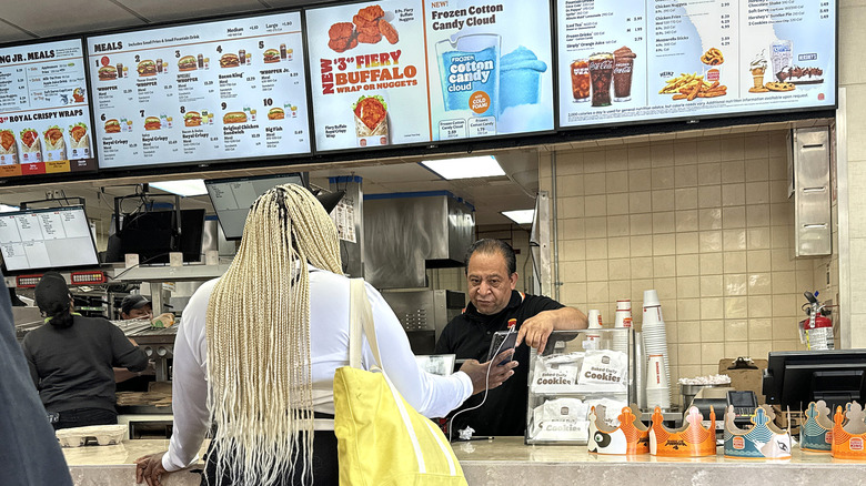 Burger King employee assisting customer