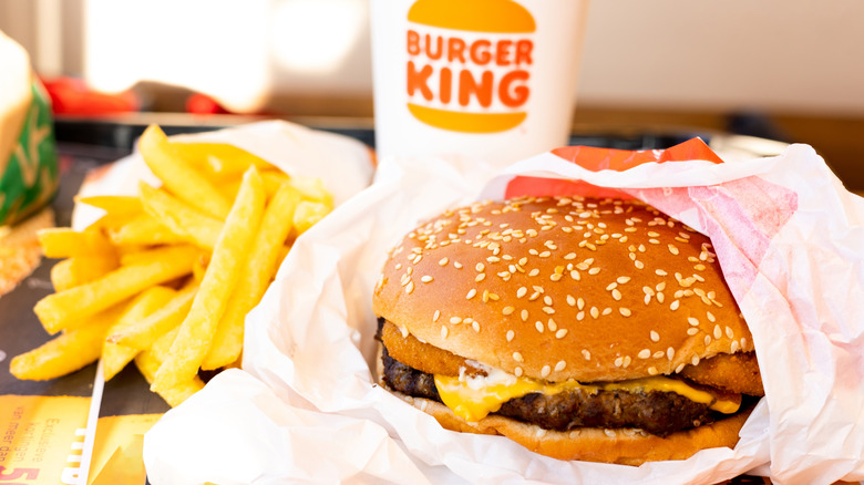 Burger King burger next to drink and fries